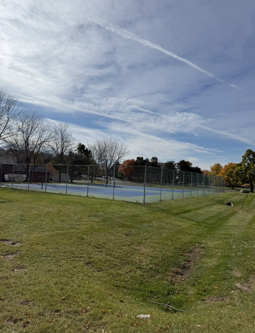 4304 West Shamrock Lane, Unit 1A McHenry, IL 60050 - Photo 20 of 20 a view of a golf course with a lake