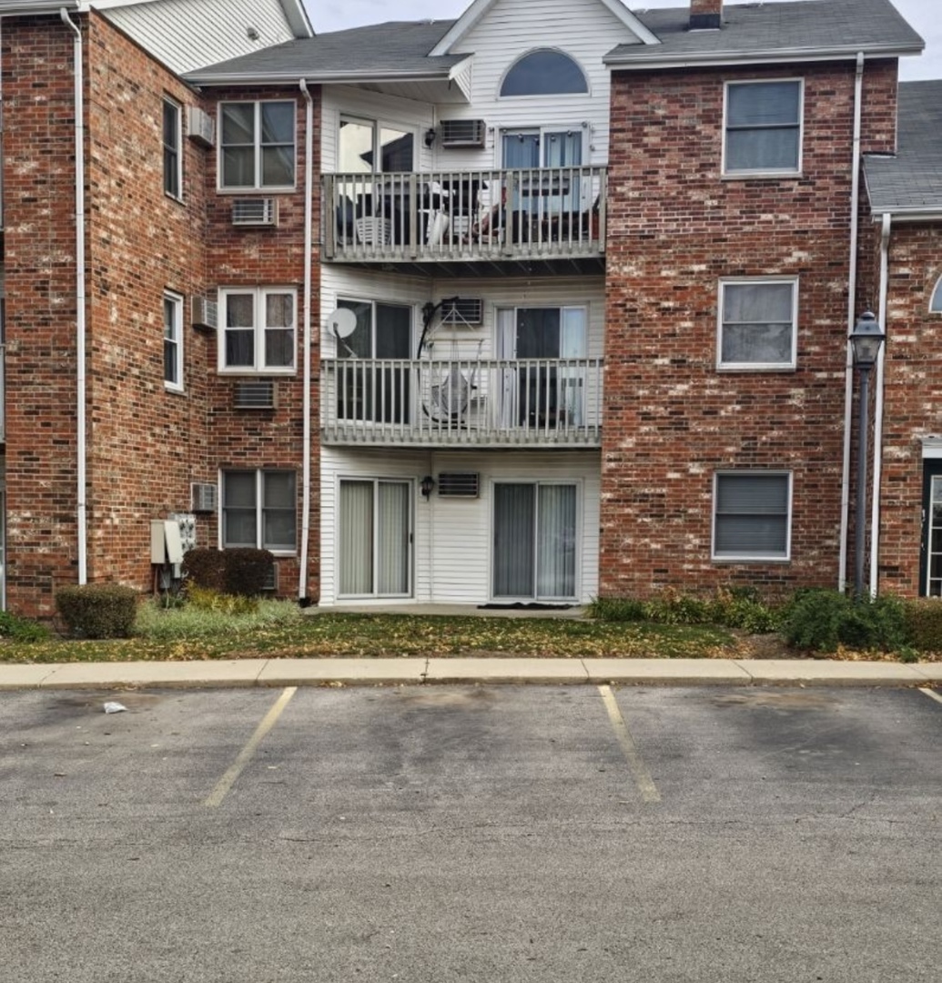4304 West Shamrock Lane, Unit 1A McHenry, IL 60050 - Photo 3 of 20 a front view of residential houses with yard