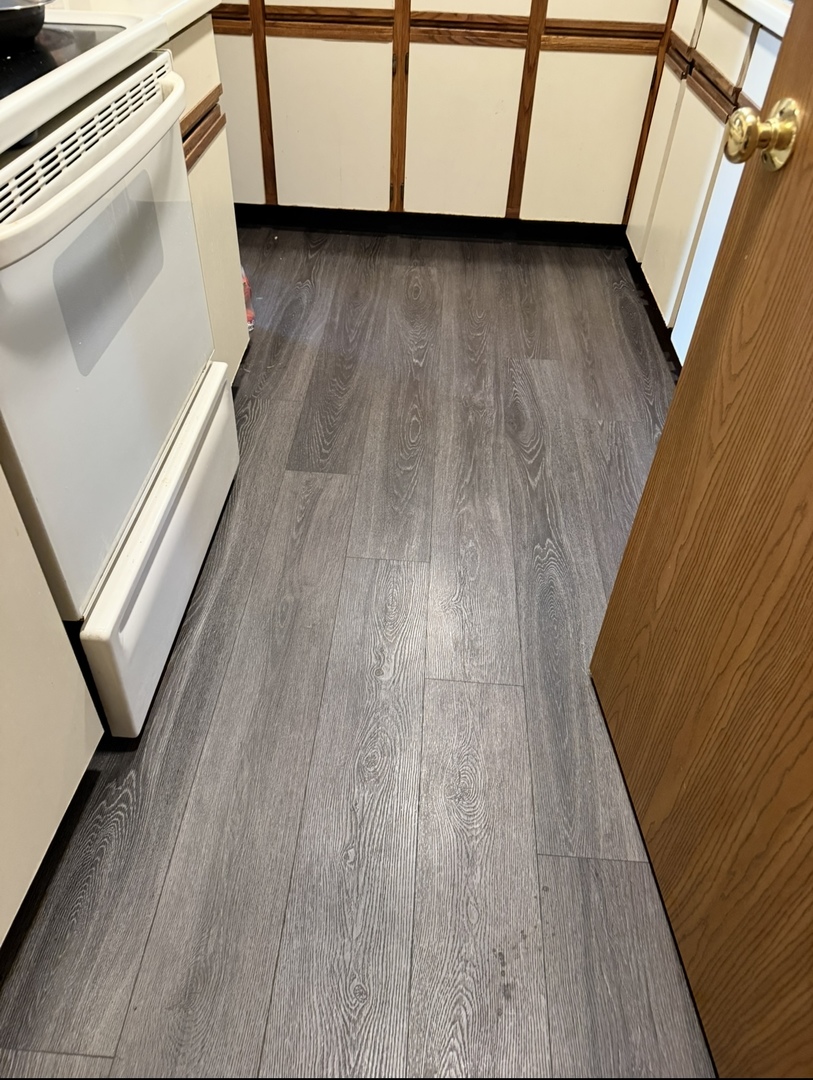 4304 West Shamrock Lane, Unit 1A McHenry, IL 60050 - Photo 6 of 20 a view of a kitchen with wooden floor