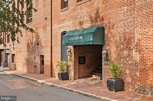 a view of a brick house with a door and wooden floor