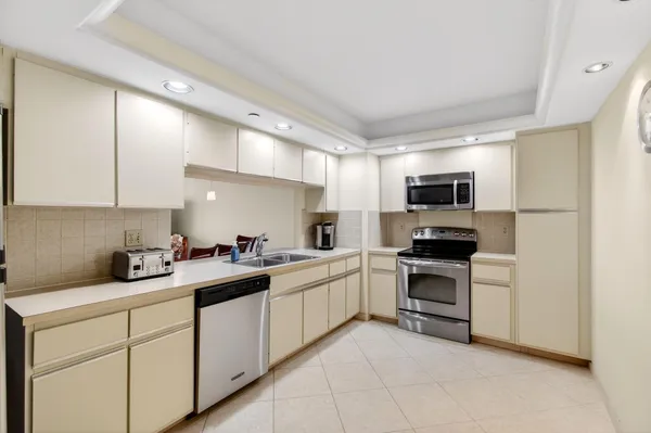 a bathroom with a double vanity sink a mirror and a shower