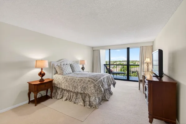 a bathroom with a granite countertop sink toilet a mirror and shower