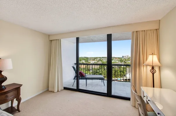 a view of a house with yard and lake view