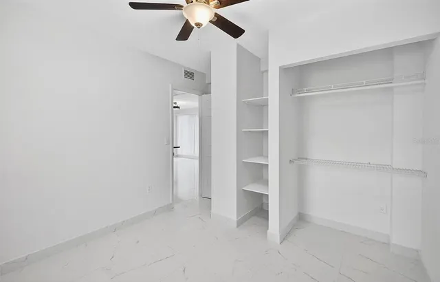 an empty room with a ceiling fan