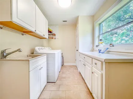 a bathroom with a sink a mirror and a window