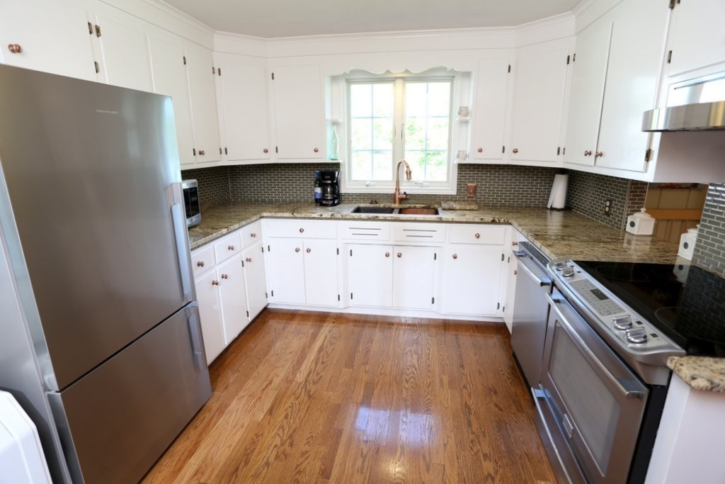 14 Fairview Road Wilbraham, MA 01095 - Photo 9 of 30 a kitchen with granite countertop a stove a sink a refrigerator and white cabinets