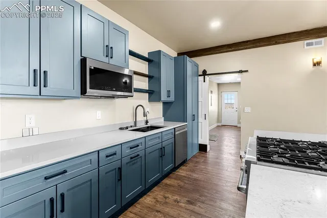 a kitchen with stainless steel appliances granite countertop a sink stove and refrigerator