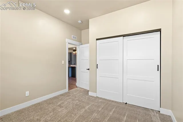 a bathroom with a shower and a glass door