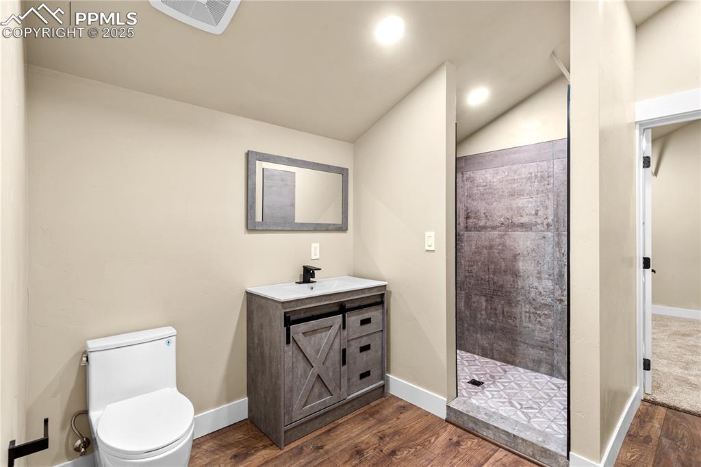 332 Yellow Bird Road Rye, CO 81069 - Photo 34 of 49 a bathroom with a toilet a sink and glass door