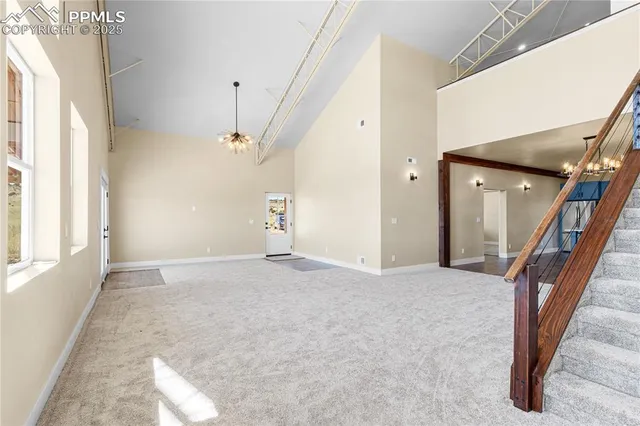 a view of a livingroom with wooden floor and stairs