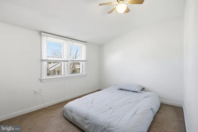 a bedroom with bed and a window