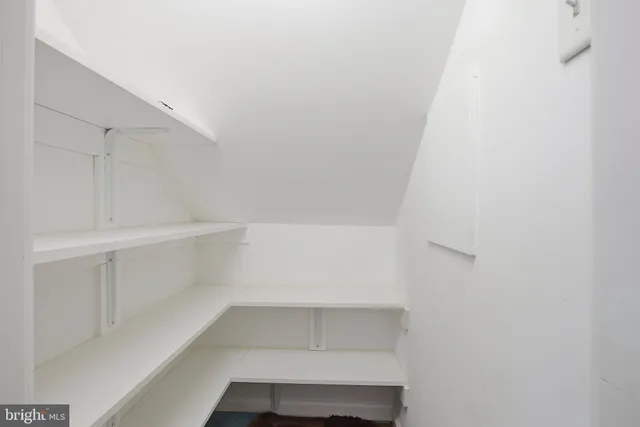 a view of empty room with white walls