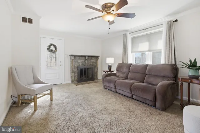 a living room with furniture and a fireplace