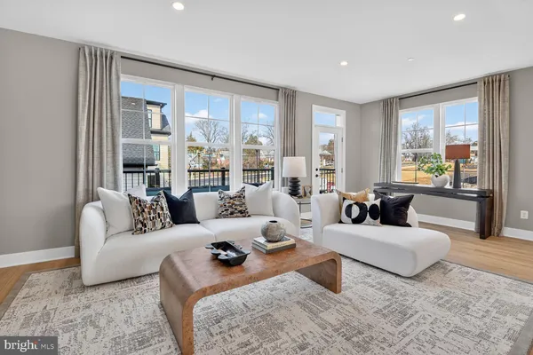 a vase of flowers sitting on a table with kitchen island