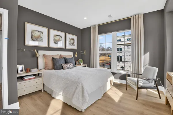 a bedroom with a bed and a large window