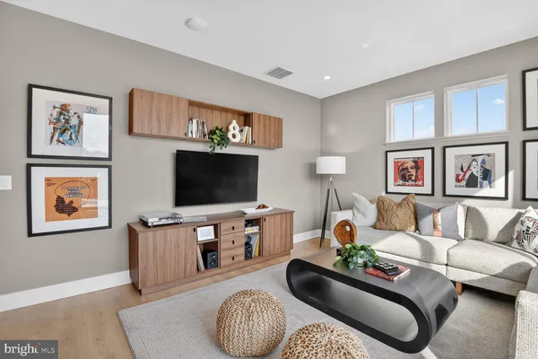 a living room with furniture and a floor to ceiling window