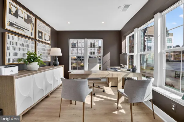 a living room with furniture fireplace and a large window