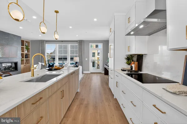 a large kitchen with lots of counter space wooden floor and appliances