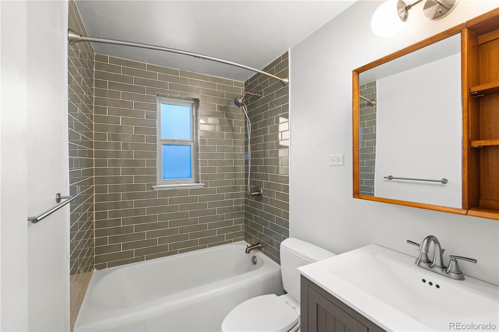 4645 East Colorado Avenue Denver, CO 80222 - Photo 11 of 34 a bathroom with a sink and bathtub with shower