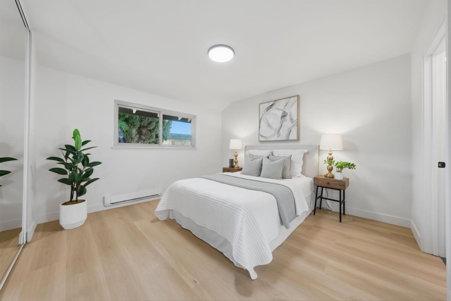 409 Puerto Place Hayward, CA 94541 - Photo 35 of 54 a bedroom with a large bed and a potted plant
