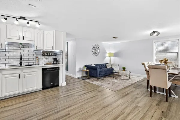 a kitchen with sink cabinets and wooden floor