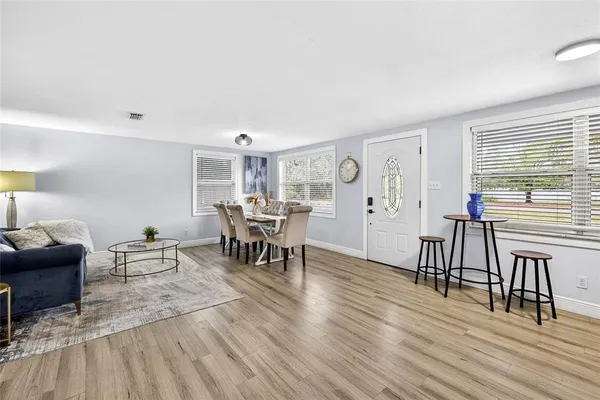 a living room with furniture and wooden floor