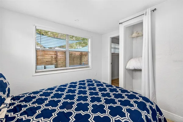 a bedroom with a bed and a window