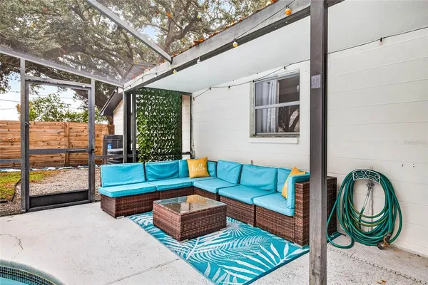 a outdoor living space with patio furniture and a rug