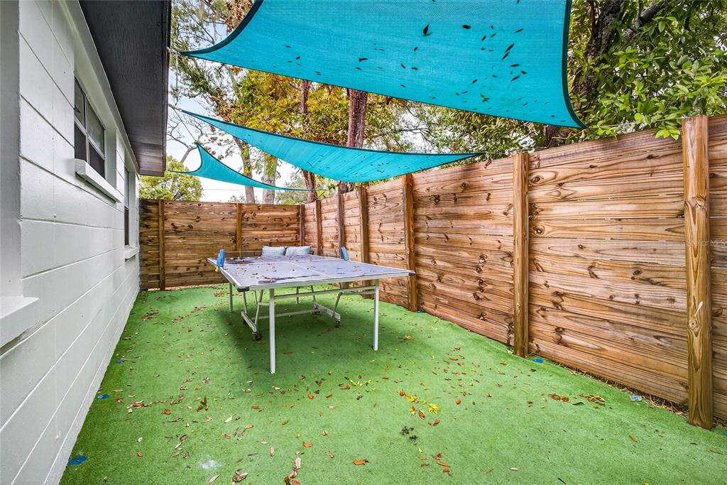 Undisclosed Address Riverview, FL 33578 - Photo 31 of 39 a backyard of a house with table and chairs