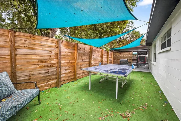 a backyard of a house with table and chairs