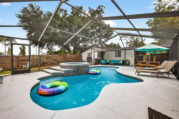 a view of a backyard with swimming pool