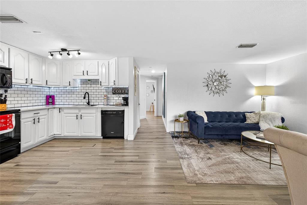 Undisclosed Address Riverview, FL 33578 - Photo 5 of 39 a kitchen with stainless steel appliances kitchen island granite countertop a stove a sink and white cabinets