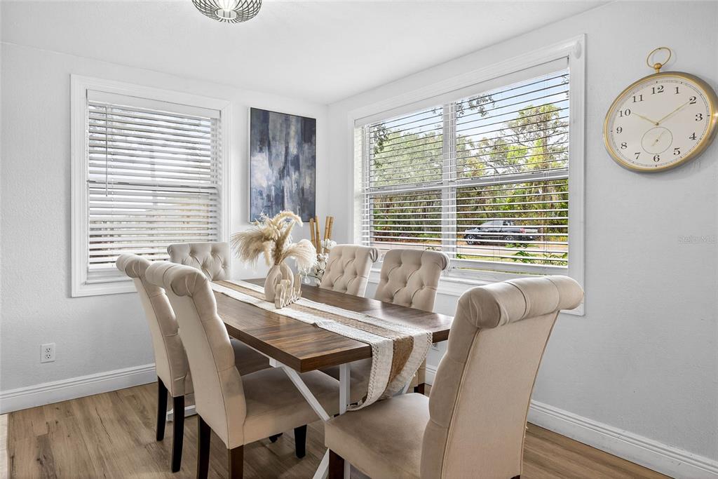 Undisclosed Address Riverview, FL 33578 - Photo 6 of 39 a view of a dining room with furniture window and wooden floor