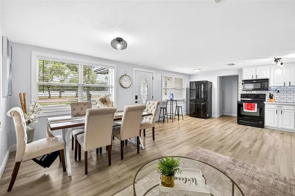 a view of a dining room with furniture and a floor to ceiling window