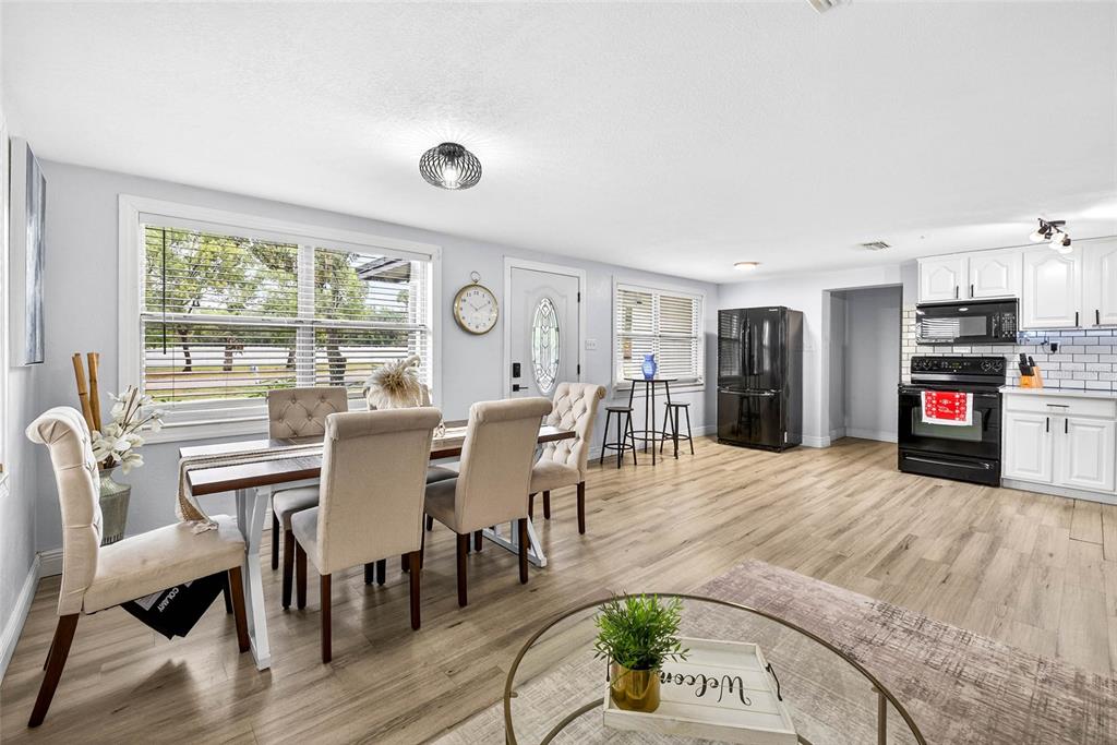 Undisclosed Address Riverview, FL 33578 - Photo 8 of 39 a view of a dining room with furniture and a floor to ceiling window