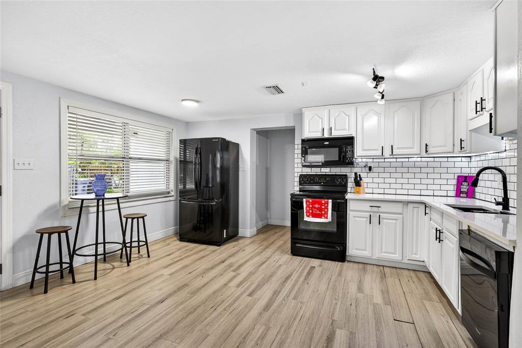 Undisclosed Address Riverview, FL 33578 - Photo 10 of 39 a kitchen with granite countertop a refrigerator stove top oven and sink