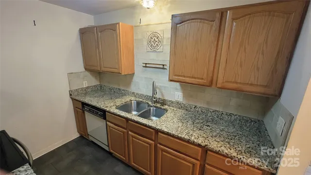 a kitchen with granite countertop cabinets and sink