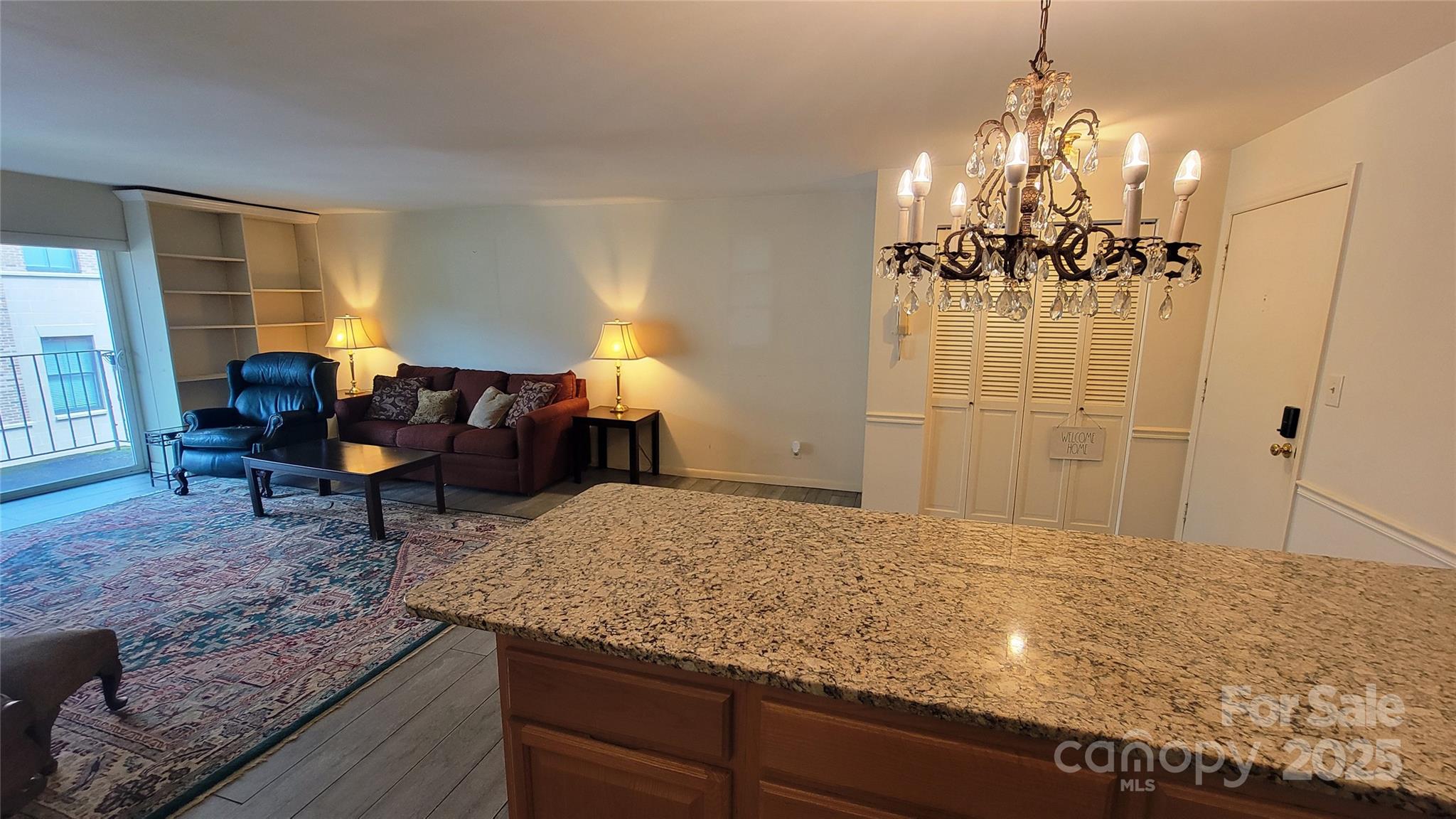 1323 Queens Road, Unit 320 Charlotte, NC 28207 - Photo 15 of 28 a living room with furniture and a chandelier