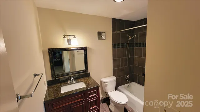a bathroom with a toilet a sink and shower