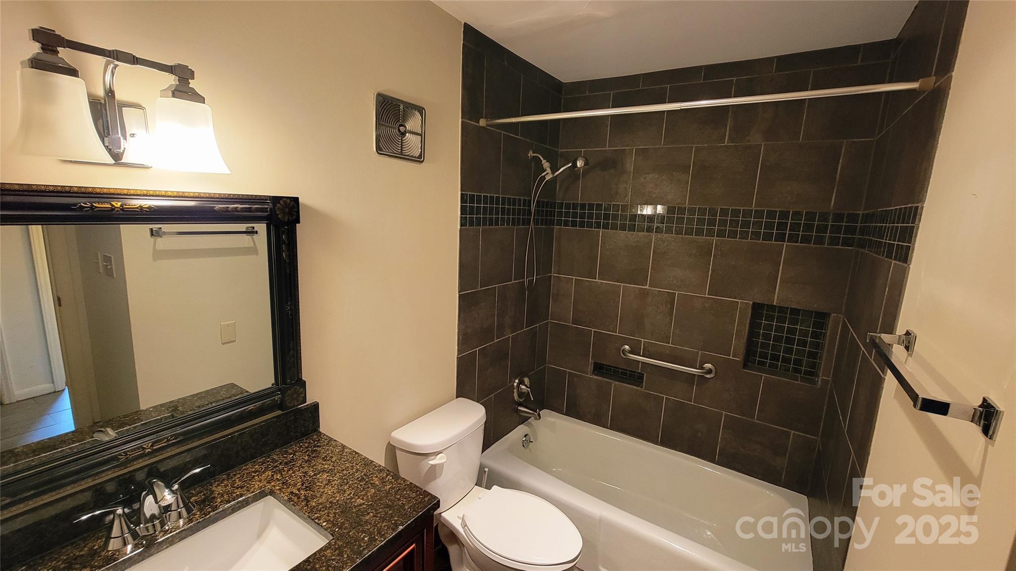 1323 Queens Road, Unit 320 Charlotte, NC 28207 - Photo 21 of 28 a bathroom with a toilet a sink and shower