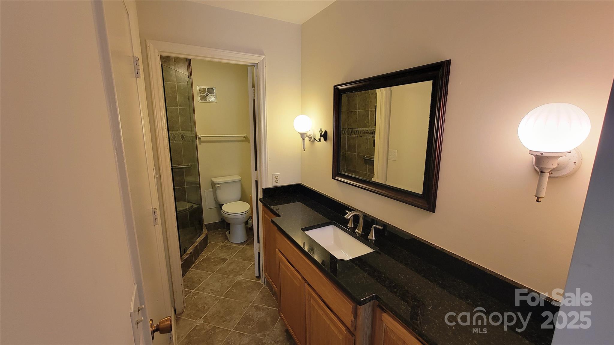 1323 Queens Road, Unit 320 Charlotte, NC 28207 - Photo 24 of 28 a bathroom with a sink and a mirror