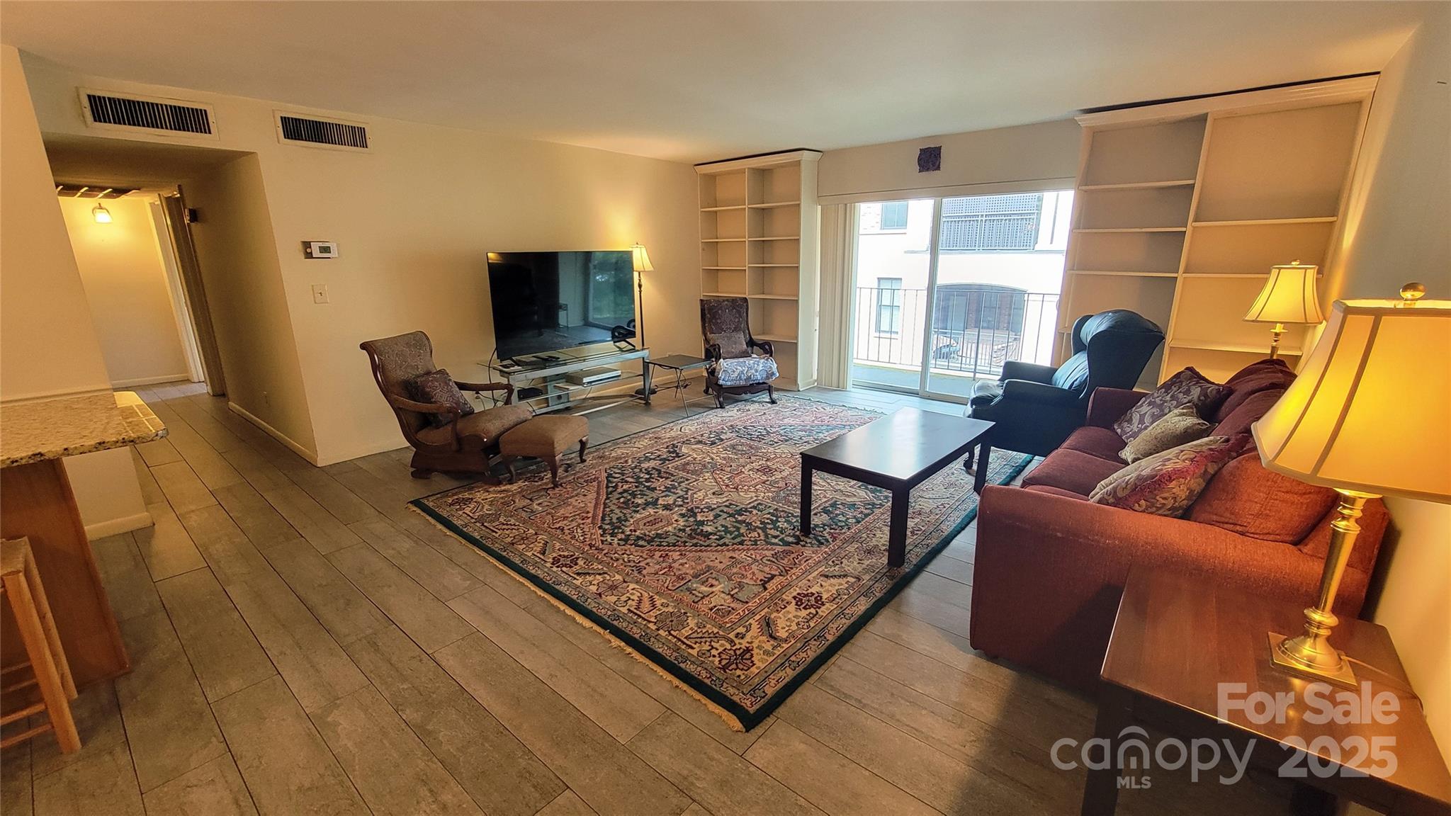 1323 Queens Road, Unit 320 Charlotte, NC 28207 - Photo 3 of 28 a living room with furniture and a flat screen tv