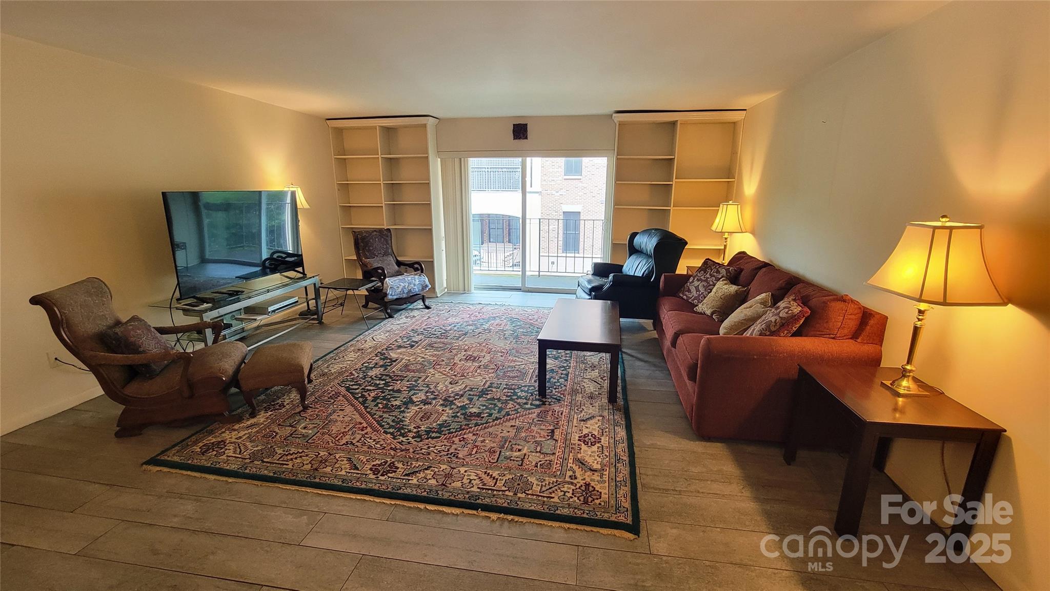 1323 Queens Road, Unit 320 Charlotte, NC 28207 - Photo 7 of 28 a living room with furniture and a lamp