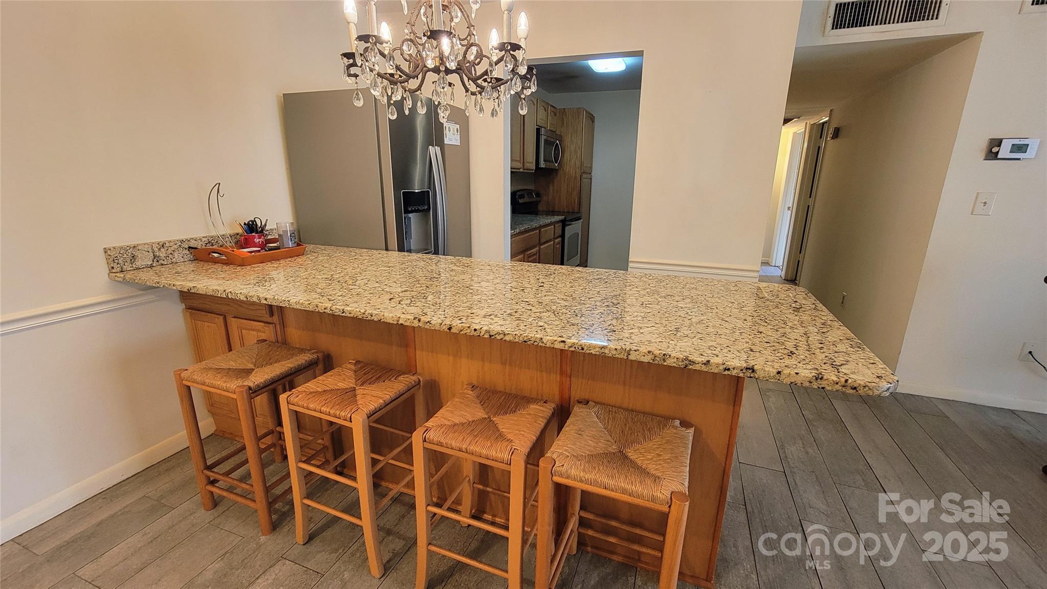1323 Queens Road, Unit 320 Charlotte, NC 28207 - Photo 8 of 28 a bathroom with a granite countertop sink a mirror and a shower