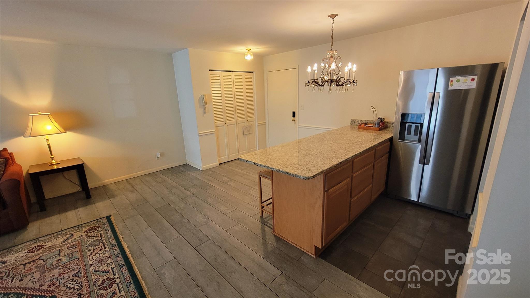1323 Queens Road, Unit 320 Charlotte, NC 28207 - Photo 10 of 28 a spacious bathroom with a granite countertop sink a mirror and shower