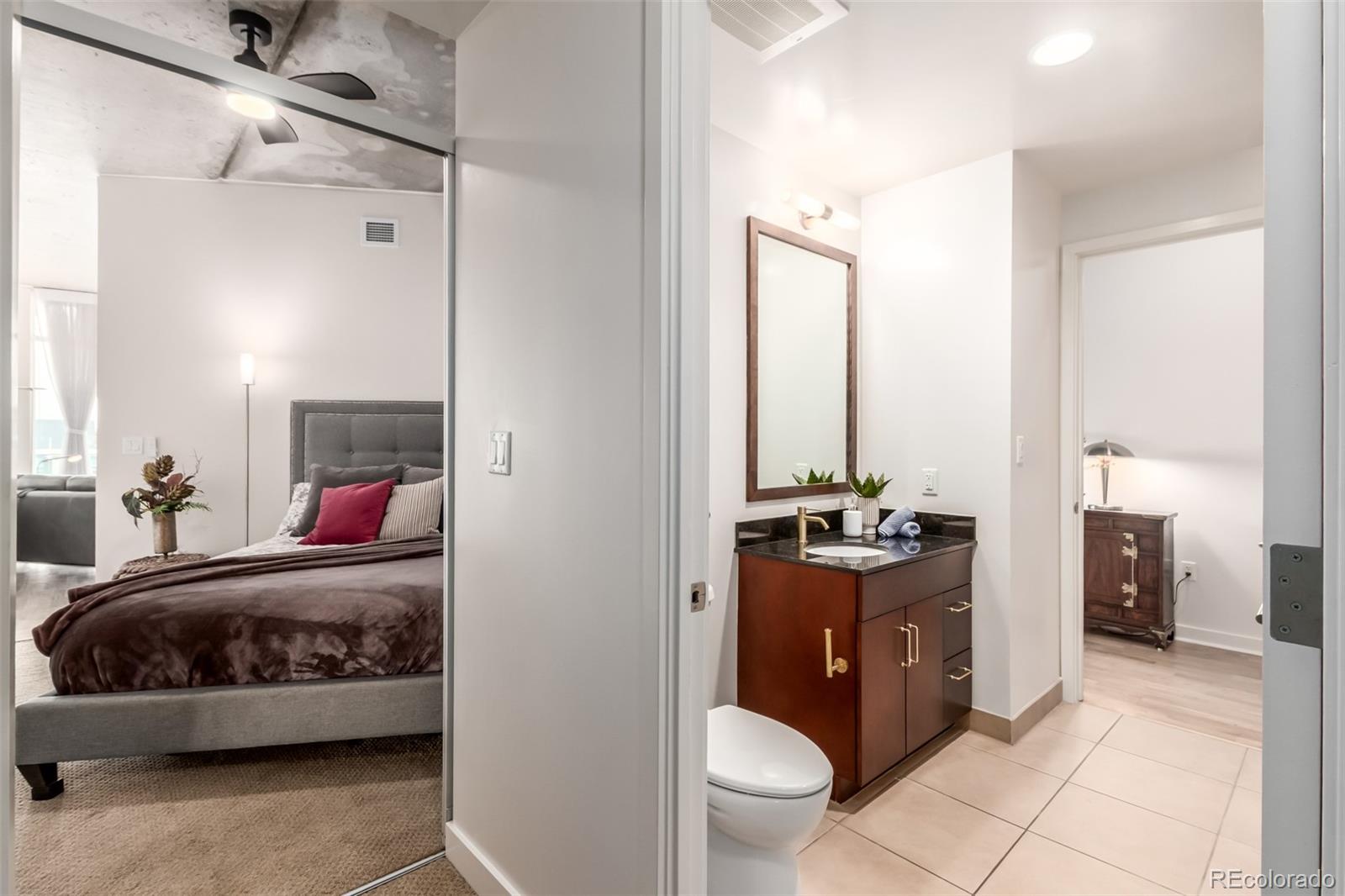 891 14th Street, Unit 3812 Denver, CO 80202 - Photo 23 of 50 a en suite bathroom with a double vanity sink a toilet a mirror and shower