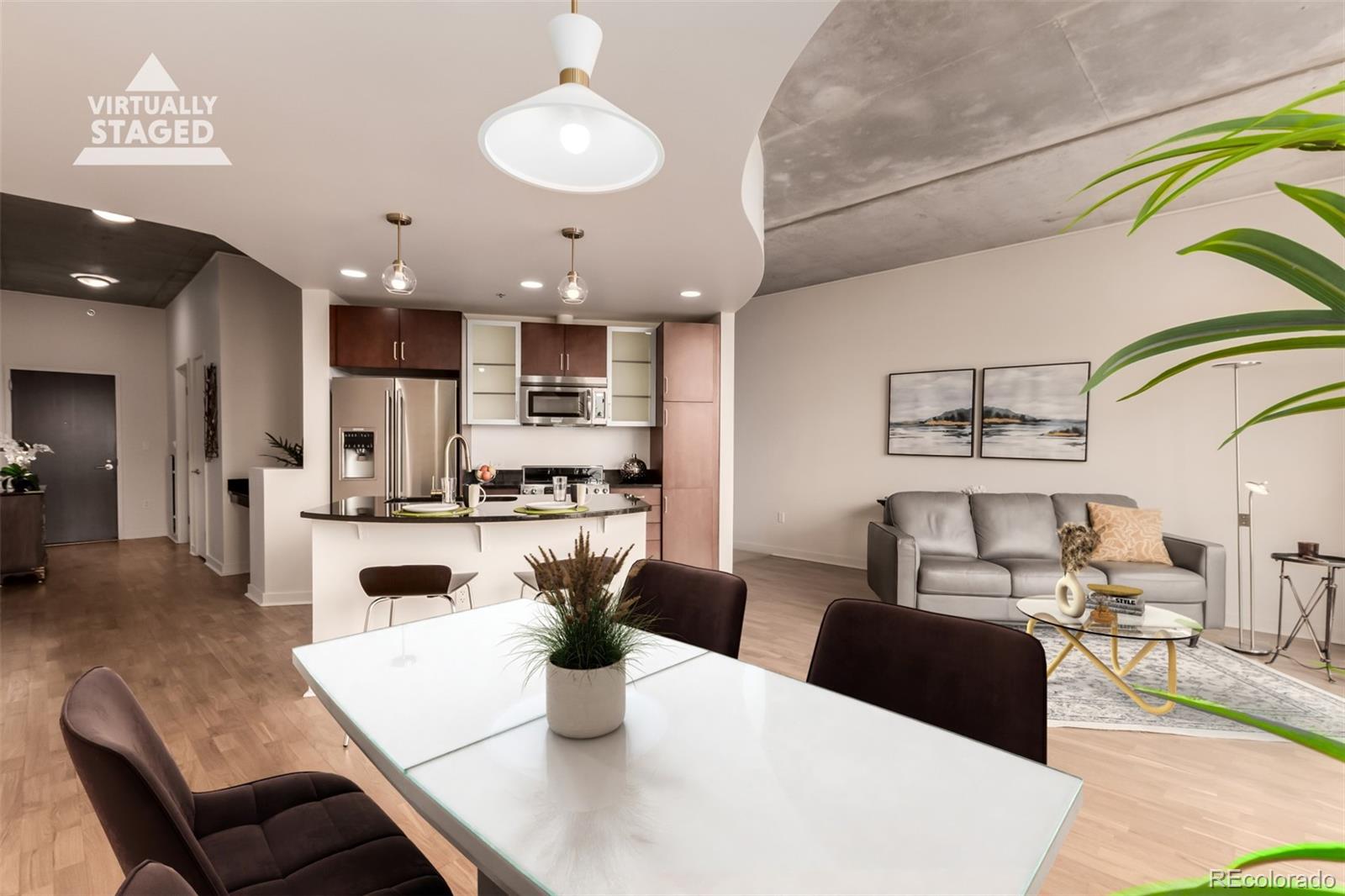 891 14th Street, Unit 3812 Denver, CO 80202 - Photo 8 of 50 a living room with stainless steel appliances kitchen island granite countertop a dining table and chairs with a dining table