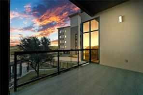 5921 Hiline Road, Unit 1203 Austin, TX 78734 - Photo 14 of 34 A spacious private balcony showcases clean architectural lines under a colorful sunset sky.
