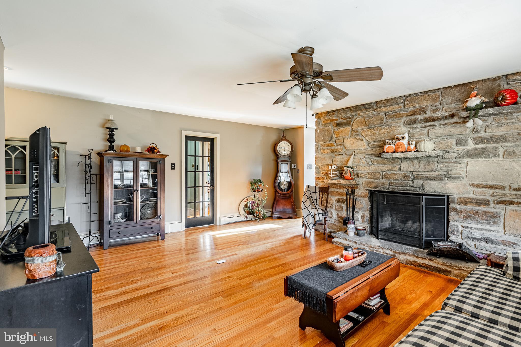 779 Concord Road Glen Mills, PA 19342 - Photo 21 of 64 a living room with patio furniture and a fireplace