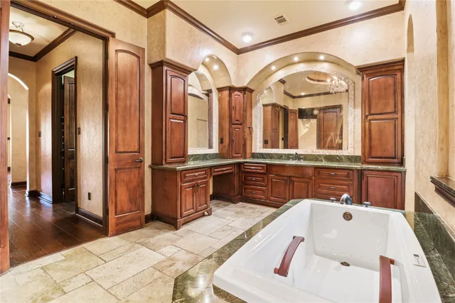 a bathroom with a tub sink and mirror